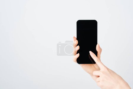 Hand of a woman holding a smartphone and white background