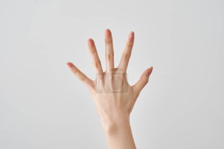 a hand in paper pose of rock-paper-scissors and white background