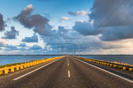 Photo for Street on the dam to the North Sea island of Romo in the Danish part of the Wadden Sea National Park which is Unesco heritage - Royalty Free Image