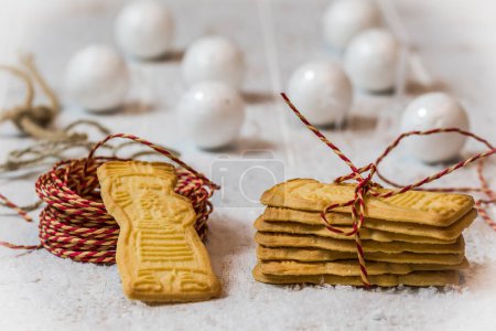 Photo for Speculoos biscuits with red ribbon on white background with Christmas decoration. European specialty for Christmas. - Royalty Free Image