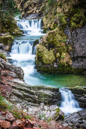 Rottach waterfall near lake Tegernsee in winter, Rottach-Egern, Bavaria, Germany, vertical
