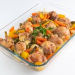 In a glass dish, baked chicken pieces with beans and carrots. The concept of proper nutrition.
