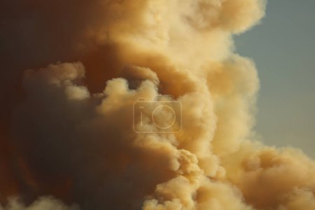 Photograph of smoke in the sky from controlled bush fire hazard reduction burning by the Rural Fire Service in the Blue Mountains in NSW, Australia.
