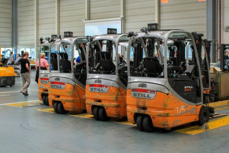 Photo for Bremen, Germany 2013. Still battery forklift trucks standing in the Mercedes factory in Bremen - Royalty Free Image