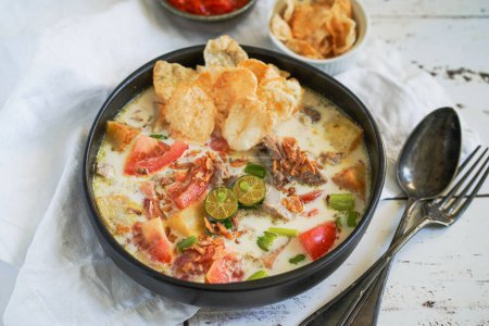 Photo for Indonesian soup : Soto Betawi served with chilli sauce sambal - Royalty Free Image