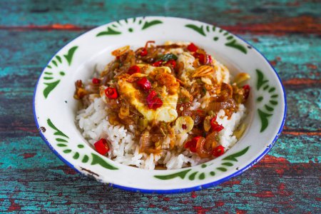 Photo for Nasi Telur Pontianak is White rice served with fried eggs cooked in chili and soya sauce - Royalty Free Image