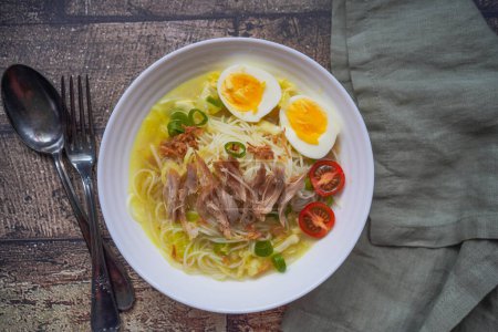 Photo for Soto is a traditional Indonesian soup mainly composed of broth, chicken, and vegetables. - Royalty Free Image