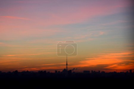 Photo for Beautiful high vanilla view of morning city, TV tower and house roofs in contrast in profile - Royalty Free Image