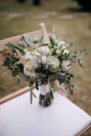 beautiful bouquet flowers and accessories for the wedding ceremony on chair, the concept of beauty