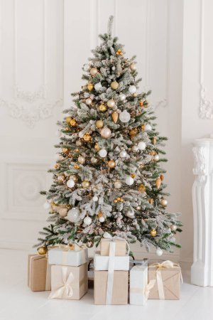 Photo for A beautifully decorated room with a Christmas tree with gifts underneath. Interior Christmas. magic luminous tree, new year. Soft selective focus. - Royalty Free Image