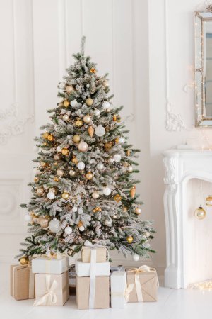 Photo for A beautifully decorated room with a Christmas tree with gifts underneath. Interior Christmas. magic luminous tree, new year. Soft selective focus. - Royalty Free Image