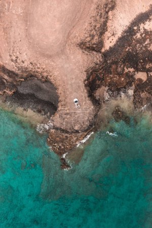 Photo for Car in Fuerteventura seashore with waves from drone - Royalty Free Image