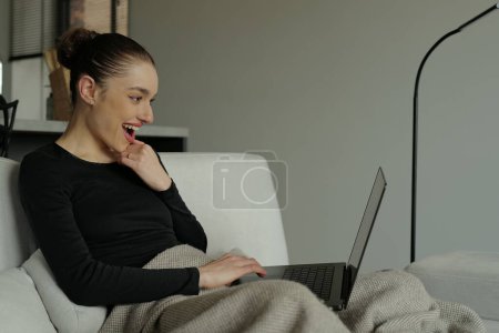 Photo for Excited surprised woman looking at laptop computer working from home - Royalty Free Image