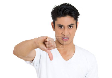 Photo for Closeup portrait of an angry, unhappy, young handsome man showing thumbs down sign, in disapproval of offer, situation, isolated on white background. - Royalty Free Image