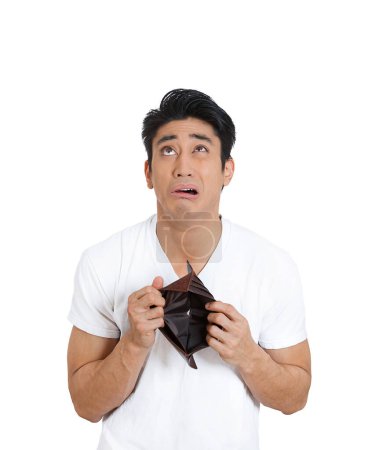 Photo for Sad desperate young man with an empty wallet isolated on white background - Royalty Free Image