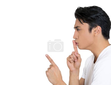 Photo for Side profile of a young handsome man giving Shhhh quiet, silence, secret gesture isolated on white background - Royalty Free Image