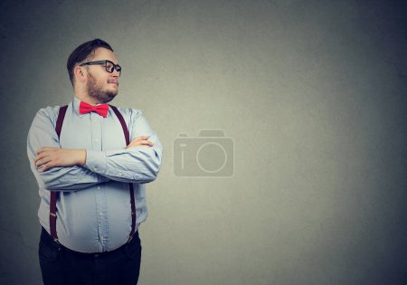 Confident eccentric businessman standing and looking to the side 