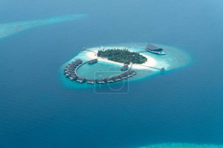 beautiful aerial view of a remote tropical island resort in one of the atolls in the Maldives.