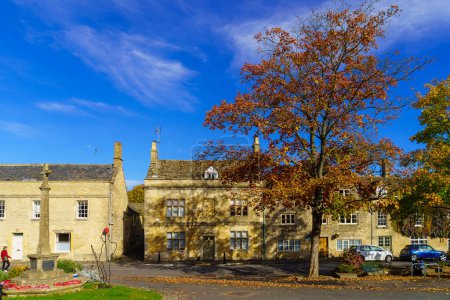 Photo for Northleach, UK - October 17, 2022: View of typical houses, with visitors, in Northleach, the Cotswolds region, England, UK - Royalty Free Image