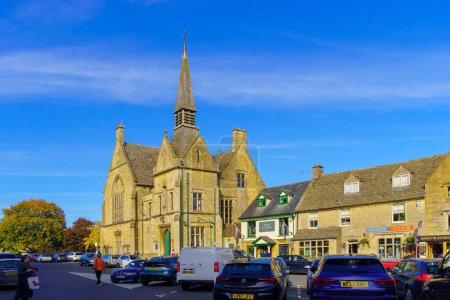 Photo for Stow-on-the-Wold, UK - October 18, 2022: View of the historic town hall building, with locals and visitors, in Stow-on-the-Wold, the Cotswolds region, England, UK - Royalty Free Image