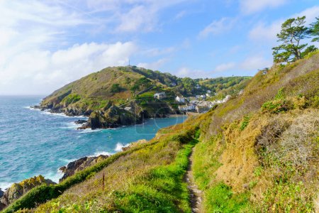 Photo for View of cliffs along the coastline, and of the village Polperro, in Cornwall, England, UK - Royalty Free Image