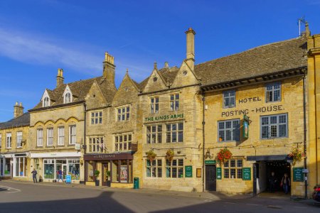 Photo for Stow-on-the-Wold, UK - October 18, 2022: Street view with various buildings, locals, and visitors, in Stow-on-the-Wold, the Cotswolds region, England, UK - Royalty Free Image