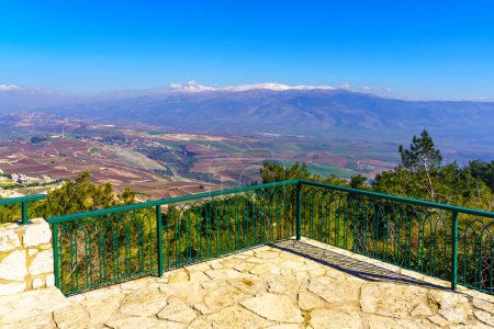 Photo for View of an observation deck, with the Hula Valley (upper Jordan River valley) and Mount Hermon in the background, Upper Galilee, Northern Israel - Royalty Free Image
