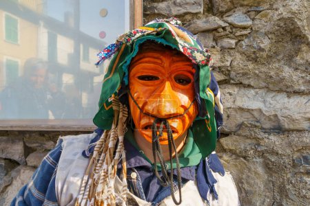 Photo for Schignano, Italy - February 18, 2023: Participant in traditional costume and mask, part of the traditional carnival of Schignano, Lake Como, Lombardy, Northern Italy - Royalty Free Image