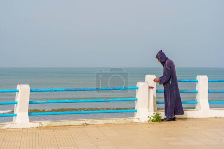 Photo for El Jadida, Morocco - April 08, 2023: View of the beach promenade, with a local, in El Jadida, the Atlantic coast of Morocco - Royalty Free Image