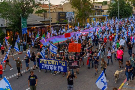 Photo for Haifa, Israel - May 27, 2023: People marching with flags and various signs. Week 21 of anti-government protest in Haifa, Israel - Royalty Free Image
