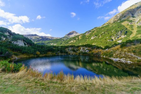 View of mountain landscape and Okoto Lake, in Pirin National Park, in southwestern Bulgaria
