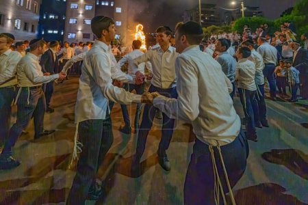 Photo for Haifa, Israel - May 25, 2024: Ultra-Orthodox Jews celebrate the Annual Holiday of Lag-BaOmer by dancing near a fire, Haifa, Israel - Royalty Free Image