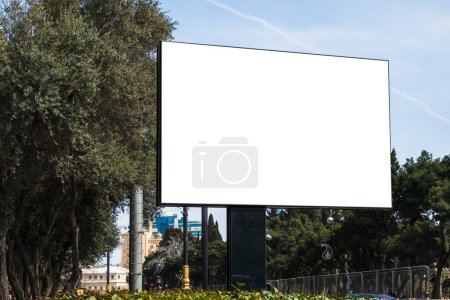 A large white billboard above the road