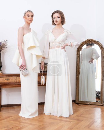 Two women in white dresses 