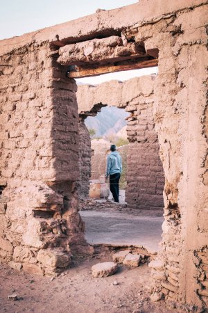 Photo for Unrecognizable man at the ruins of Mayorazgo de Anillaco in Catamarca, Argentina. Traditional adobe construction - Royalty Free Image