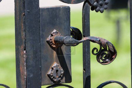 Steel fence, patterned old handle to open the gate approximately