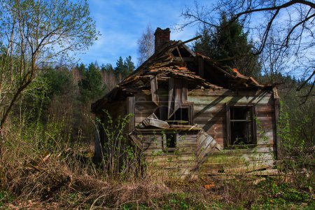 Photo for The old abandoned wooden house has been destroyed, the passing of good time, the roof collapsed, nobody cares about it anymore - Royalty Free Image
