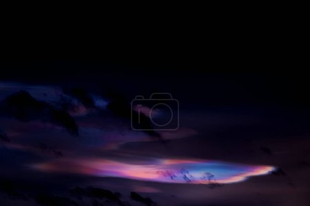Photo for Beautiful Iridescent Pileus Cloud,Rare Natural of Sunset Sky of Fire Rainbows or Rainbow Clouds.Dark Cloud with Colorful optical Phenomenon sky in Winter Evening in UK - Royalty Free Image