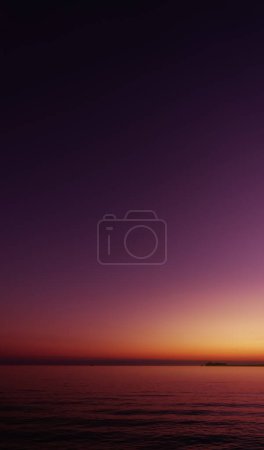 Sunset Sky Background,Beautiful Nature Landscape Summer Sun dawn in Purple,Orange,Pink,Yellow,Twilight sky in the Evening by Sea beach,Romantic Sunrise Sky in Spring, Vertical Dusk sky with sea wave