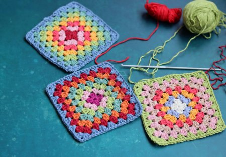 Granny squares pattern close up photo. DIY project in process. Textured background with copy space. Crocheting ideas. 