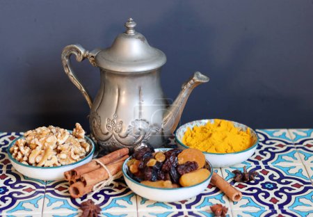 Téléchargez les photos : Still life with Traditional oriental spices, nuts, herbs and dried fruit on blue tiled background. Healthy eating concept. - en image libre de droit