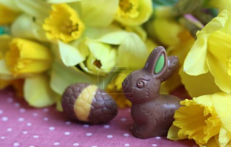 Photo for Milk chocolate bunny and eggs on a table. Bright and colorful Easter card. - Royalty Free Image