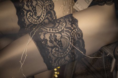 Photo for Close up of black lace stockings on mannequin in fashion store showroom - Royalty Free Image