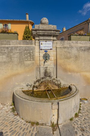 Photo for Water fountain on the village square of Rasteau in the Vaucluse - Royalty Free Image