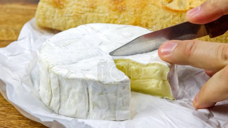 piece of camembert cut with a knife