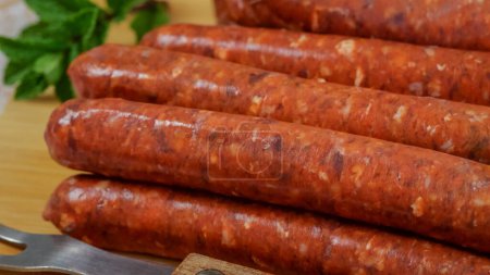 several raw merguez sausages, close-up, on a cutting board