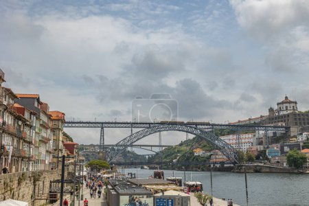 Photo for Porto, North Region, Portugal - 05302023 : view of the river Douro, the Dom Luis Bridge, the old city of Porto and the cais de ribeira - Royalty Free Image
