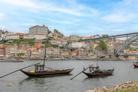 Photo for Rabelo boat in the foreground, Dom Luis Bridge and the city of Porto (Portugal) - Royalty Free Image