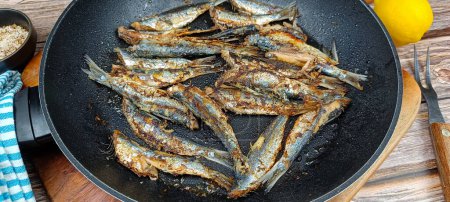 Several sardines cooking in a pan. Big plan.