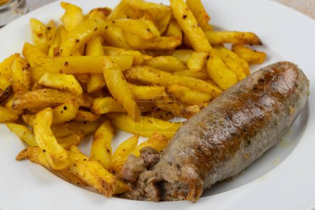 andouillette and fries, close-up, on a plate
